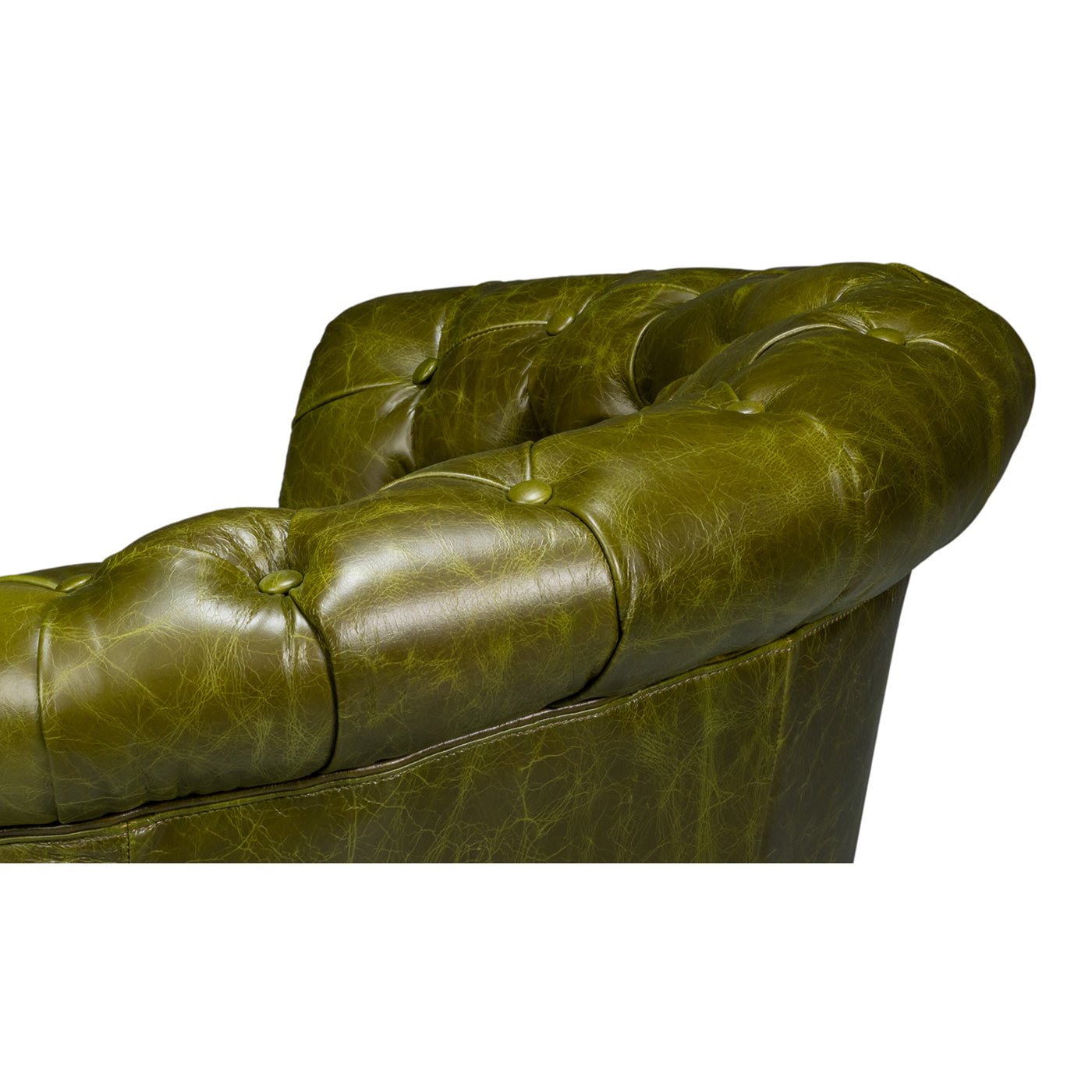Green leather barrel back chair, top tufting detail.