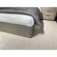Corner detail of Grey Art Deco bed frame with comforter.