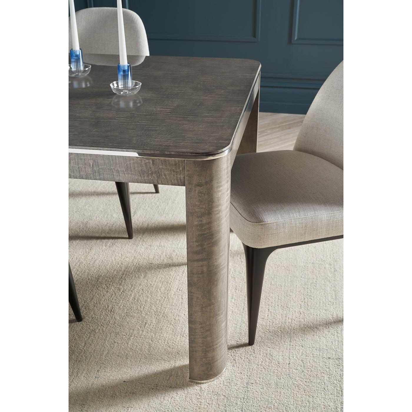 Table set with chairs emphasizing rounded corner design.