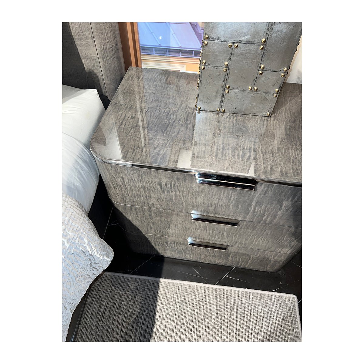 Top view of grey Art Deco nightstand with decor