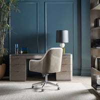 Desk and chair in home office setting.