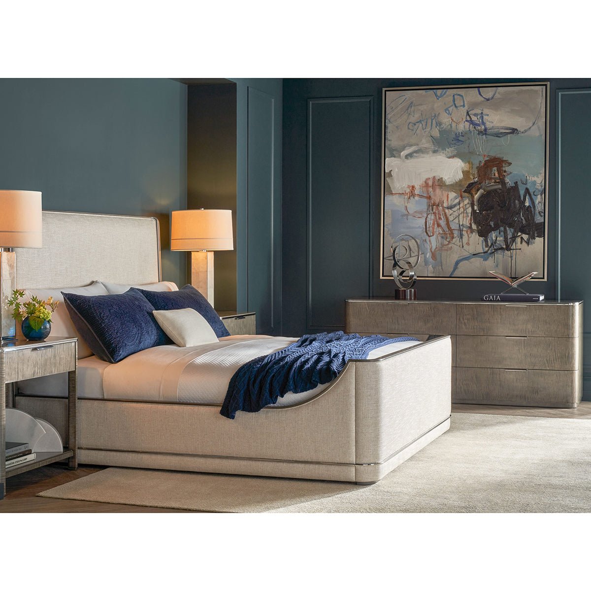 Bedroom with bed, dresser, art decor on wall.