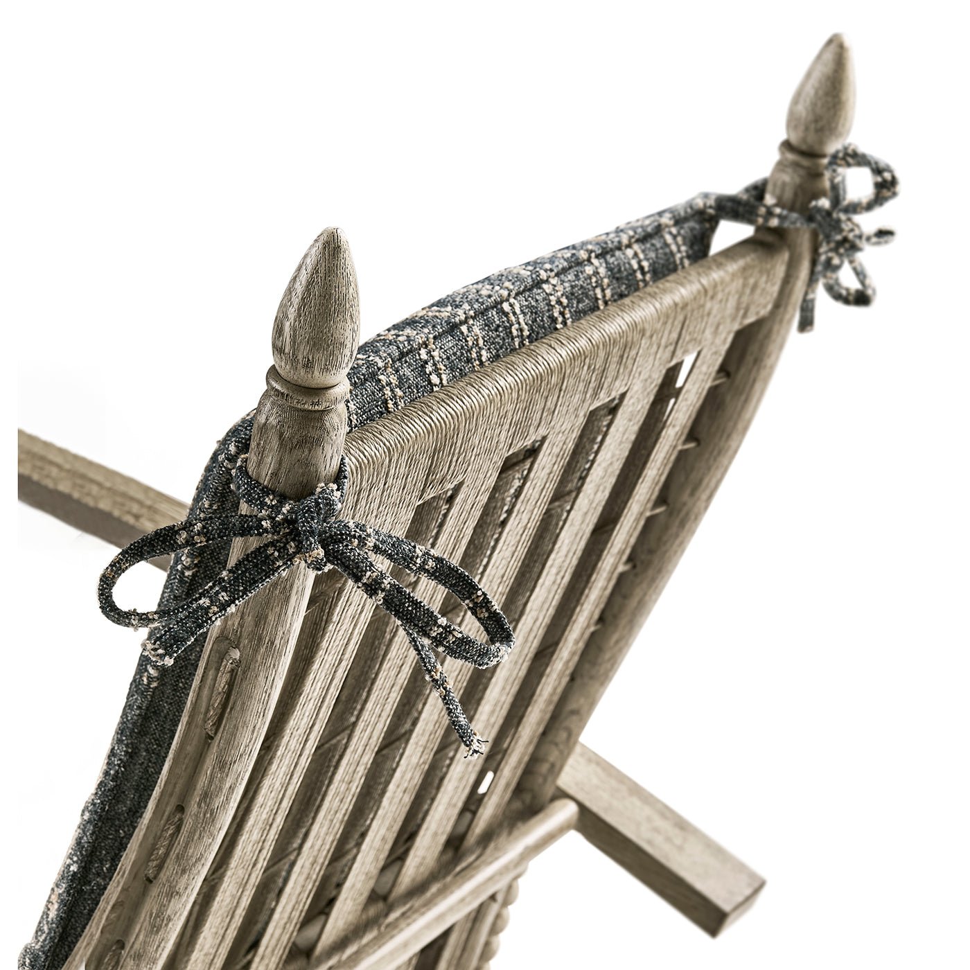 Back of lounge chair, decorative ribbon ties, top detail.