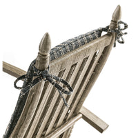 Back of lounge chair, decorative ribbon ties, top detail.