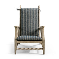 Lounge chair with striped cushion, detailed front view.