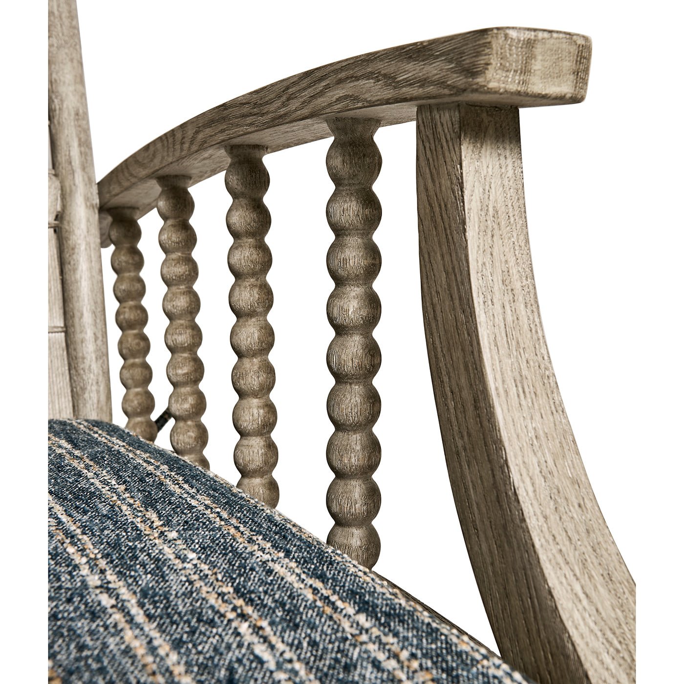 Armrest design, spindle detailing, lounge chair close-up.