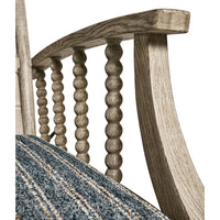 Armrest design, spindle detailing, lounge chair close-up.