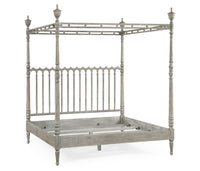 Greyed oak bed frame without mattress, four-post design.