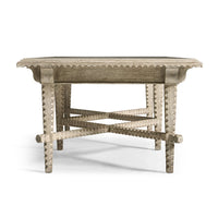 End view of rustic coffee table with ornate legs.