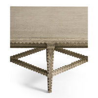 Rustic table corner with detailed leg construction.
