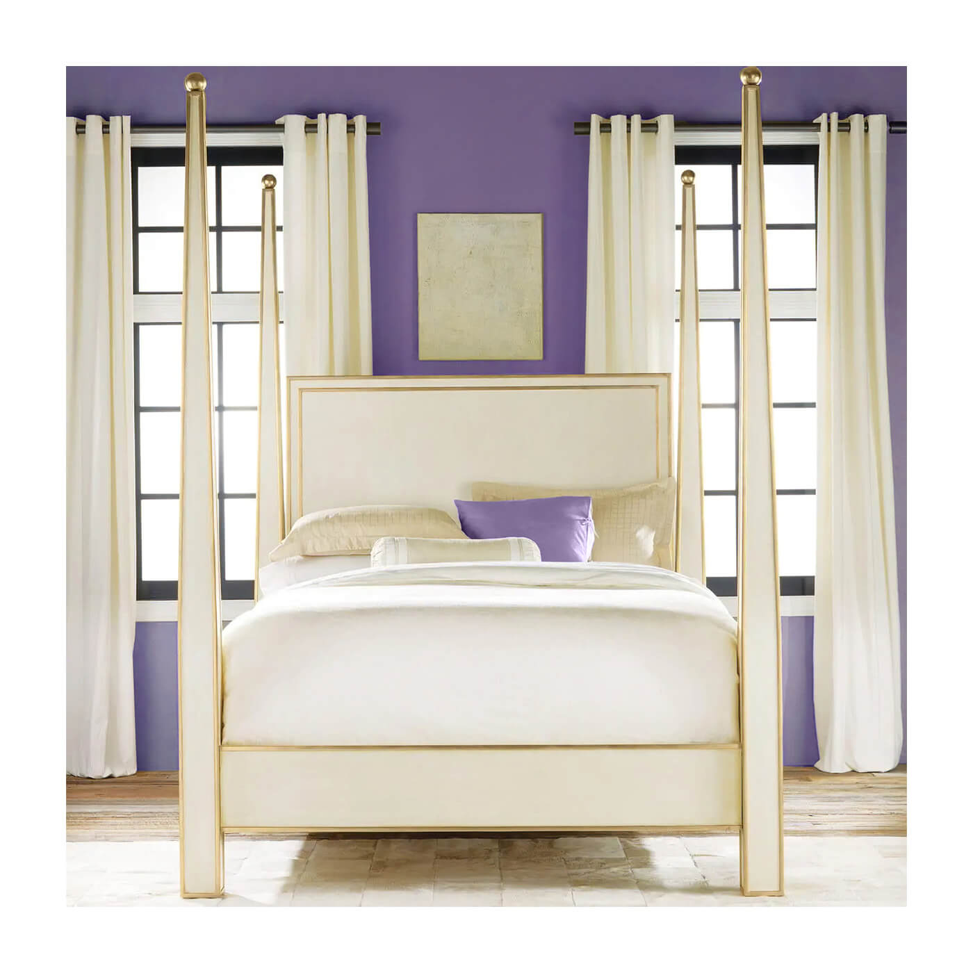 Cream four poster bed in purple-walled bedroom.