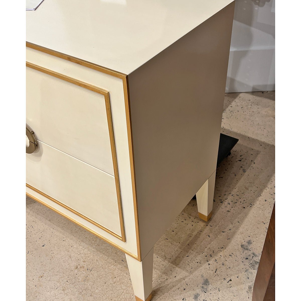 Side view of nightstand showing elegant gold trim details.