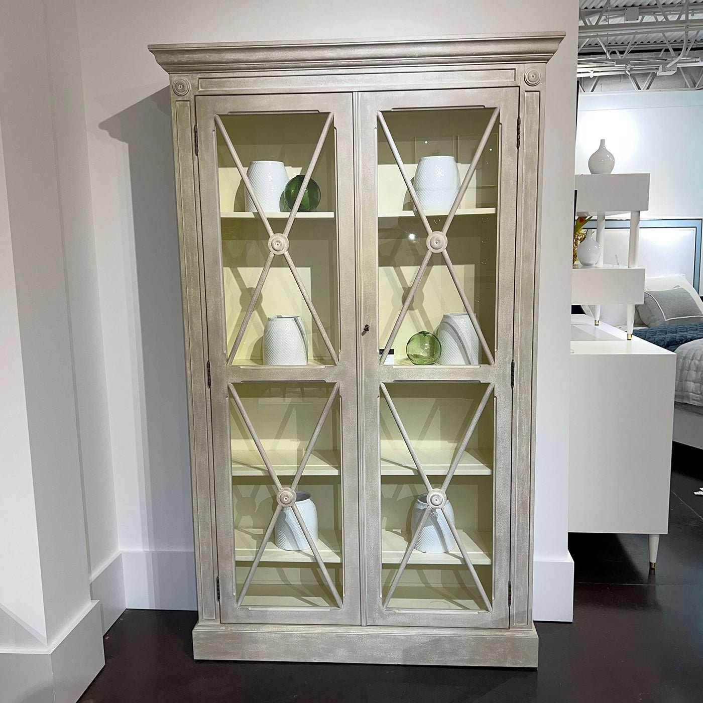 Gustavian display cabinet, styled with white vases, showroom setting.