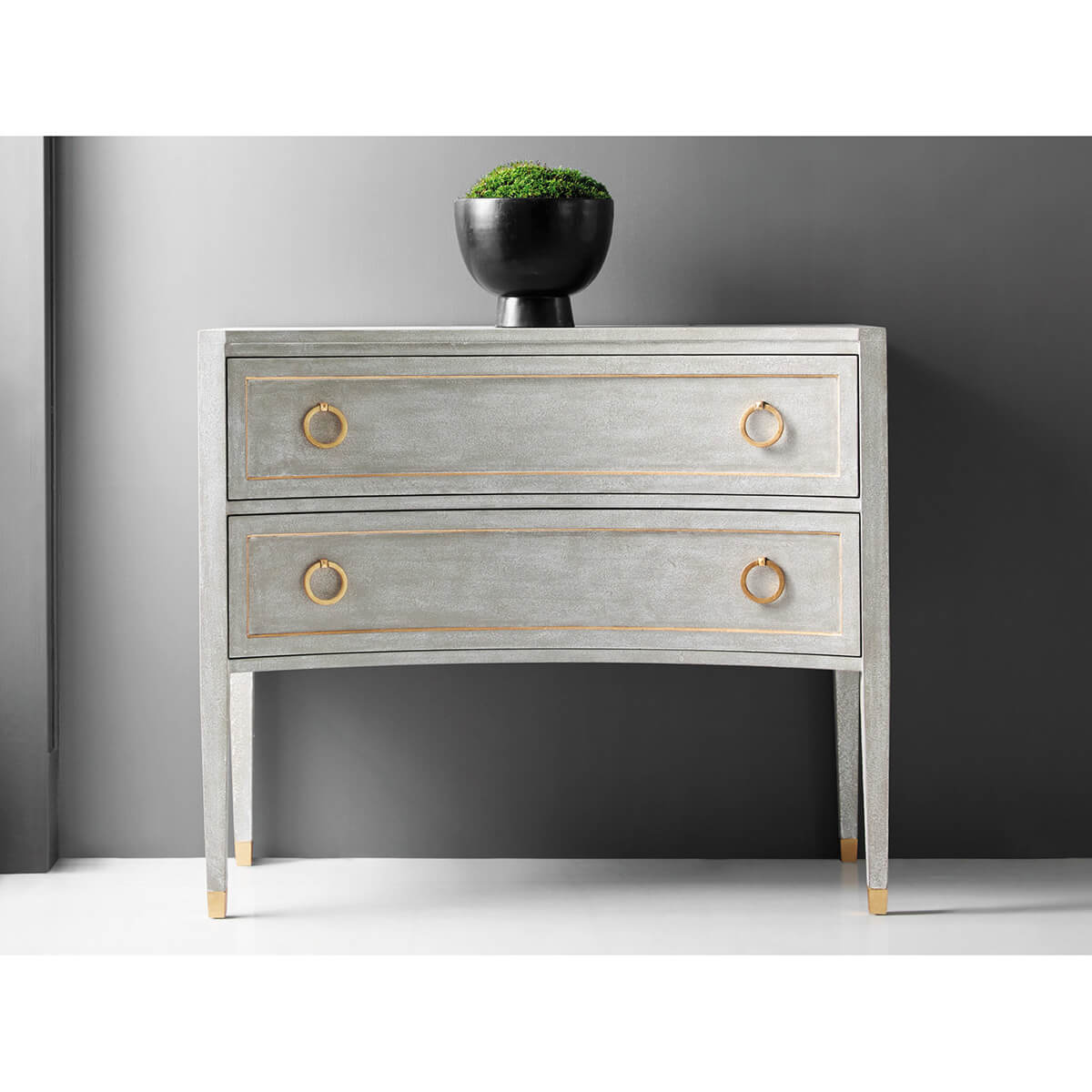 Gustavian dresser styled with plant, grey wall background.