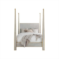 Front view of four-poster bed with pillows.