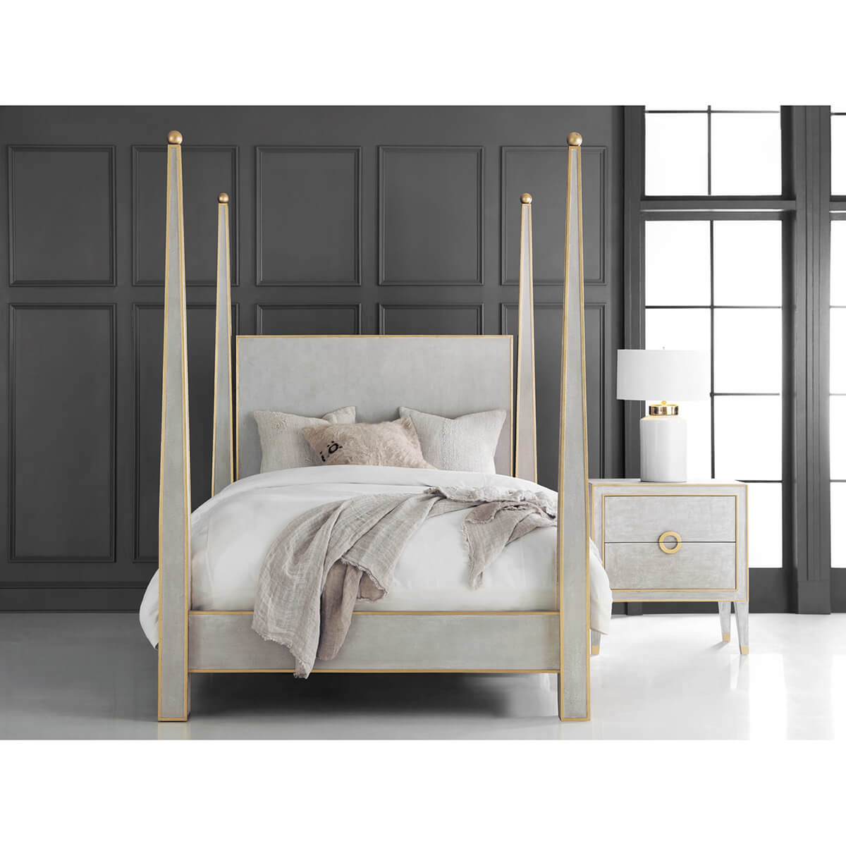 Four-poster bed in grey room, matching nightstand.