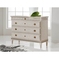 Swedish dresser in bright room with decorative top detail.