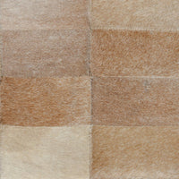 Close-up of the Canyon Sand bench upholstery showing tan and cream hair-on-hide patchwork squares