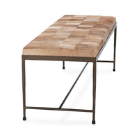 Angled end view of the Canyon Sand hair-on-hide bench showing its patchwork seat and iron frame