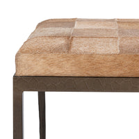 Close-up of the Canyon Sand bench’s hair-on-hide seat edge and textured iron apron