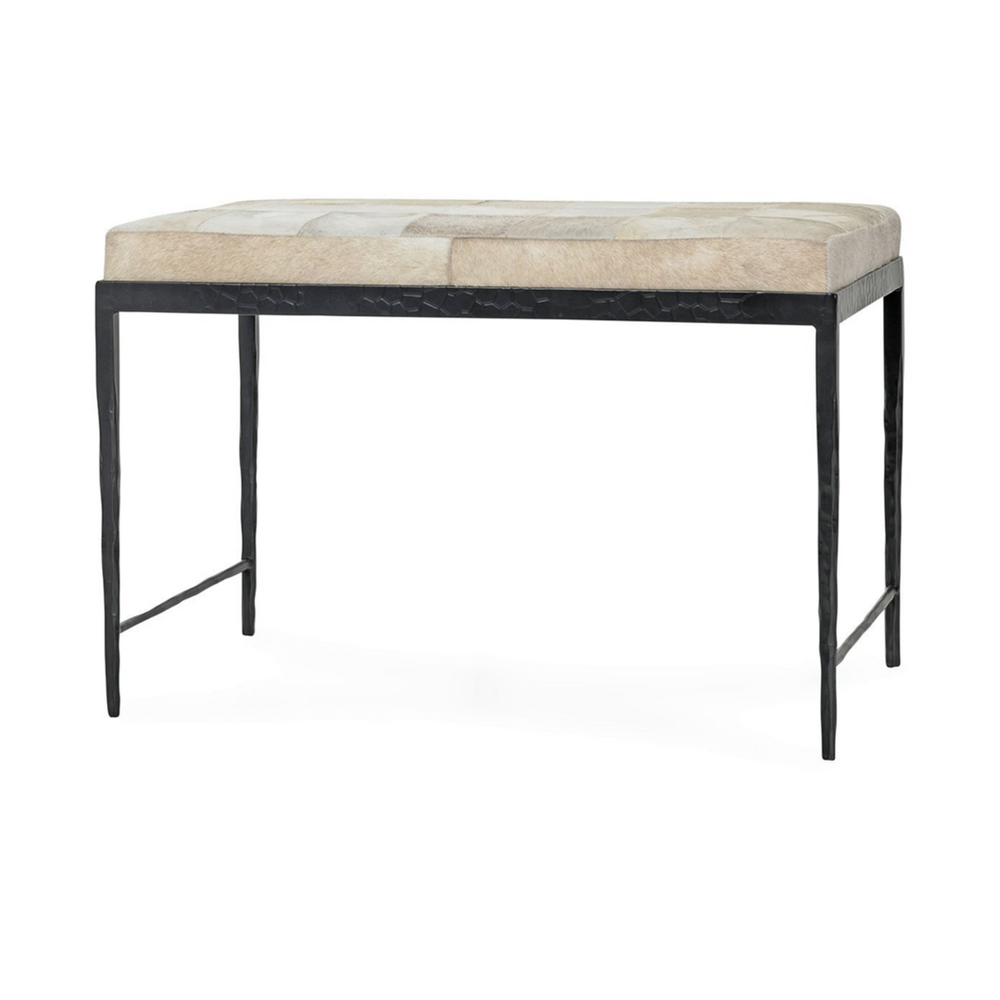 Dusty Cream hair-on-hide bench at an angle, with a pale patchwork seat and slim black iron frame