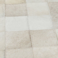 Close-up of the Dusty Cream bench upholstery showing cream and beige hair-on-hide patchwork squares