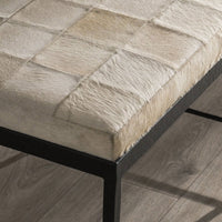 Angled close-up of the Dusty Cream bench seat corner and embossed black iron frame