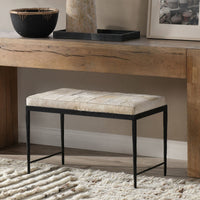 Dusty Cream hair-on-hide bench with a black iron frame beneath a wood console on a textured rug