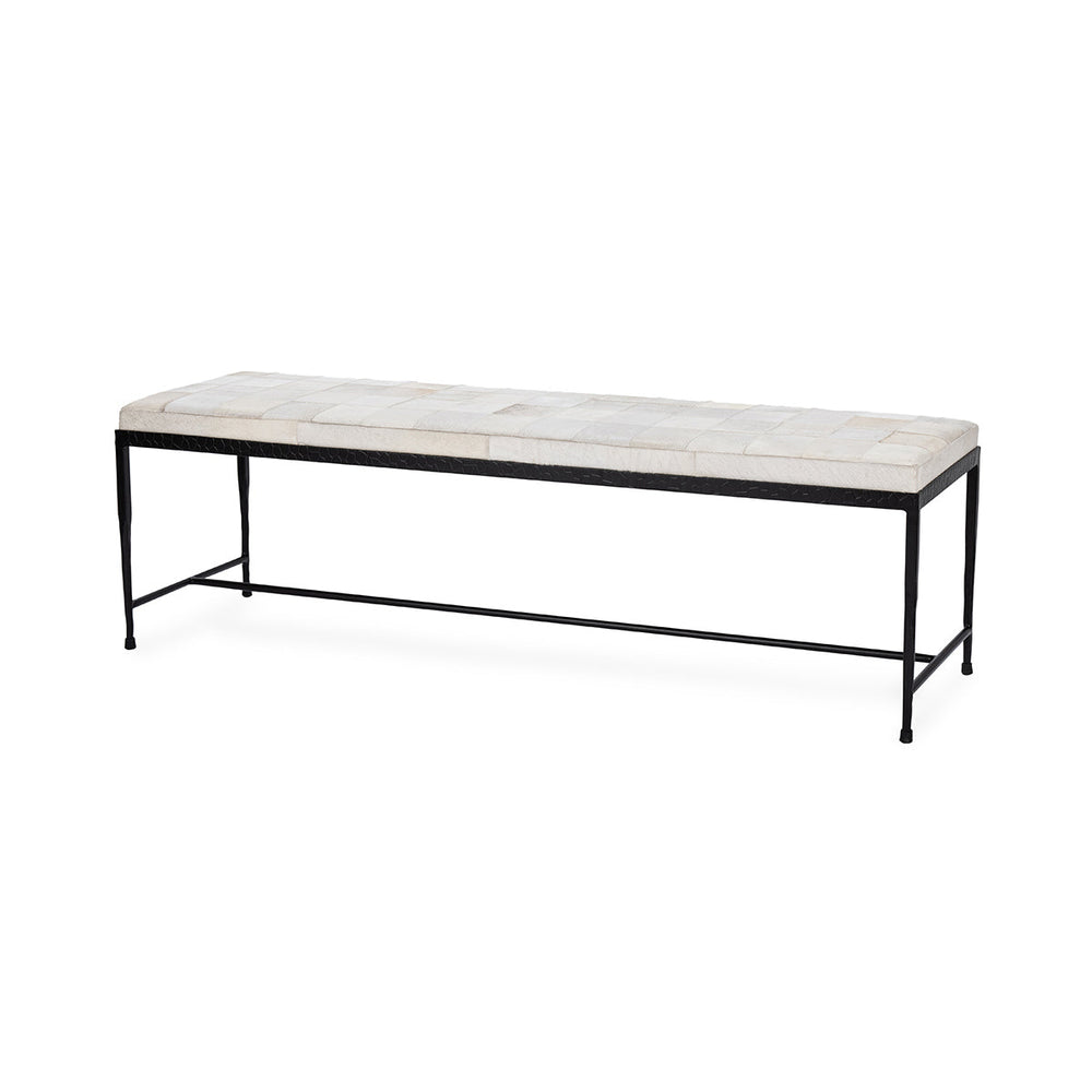 Angled view of the 60-inch Dusty Cream hair-on-hide bench with patchwork seat and slender black iron frame