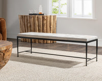Dusty Cream hair-on-hide bench with a black iron frame on a cream rug beside rustic wood furniture