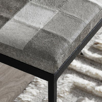 Close-up of the compact Sparrow Gray bench showing its patchwork seat corner and textured black iron apron