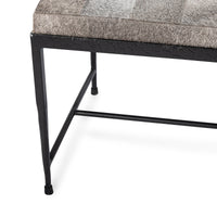 Close-up of the Sparrow Gray bench showing a tapered iron leg, low stretcher and patchwork seat edge
