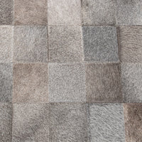 Close-up of the Sparrow Gray bench upholstery showing stitched squares of gray and taupe hair-on-hide
