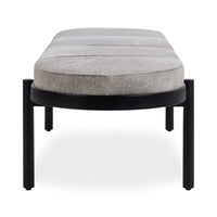 End view of the oval hair-on-hide bench showing the rounded gray cushion and curved black iron rim