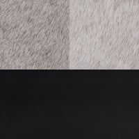 Close-up of the oval bench materials: gray hair-on-hide upholstery above a smooth black iron rim