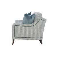 Blue patterned modern sofa, side view with cushions.