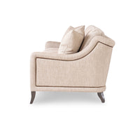 Beige modern sofa, side profile with curved armrest.