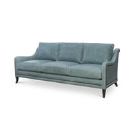Blue modern sofa, angled front view with sleek cushions.