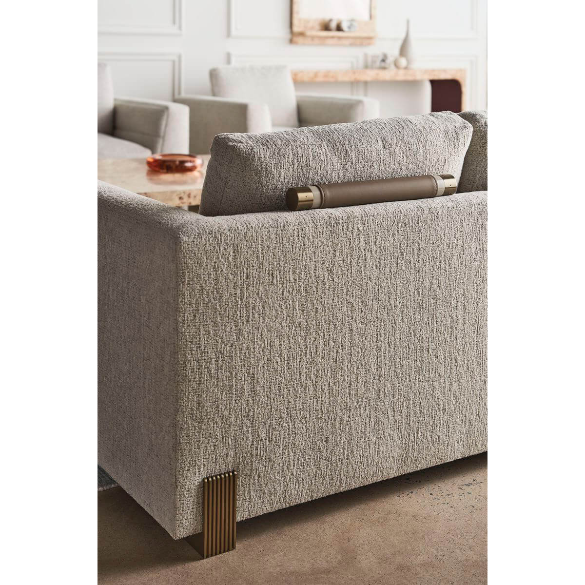 Close-up of Harmony Modern Sofa's textured fabric and legs.