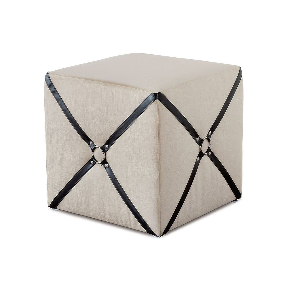 Beige harness cube ottoman with black straps.