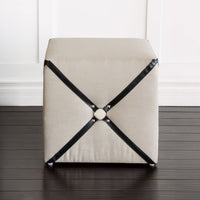 Front view of harness cube ottoman against wall.