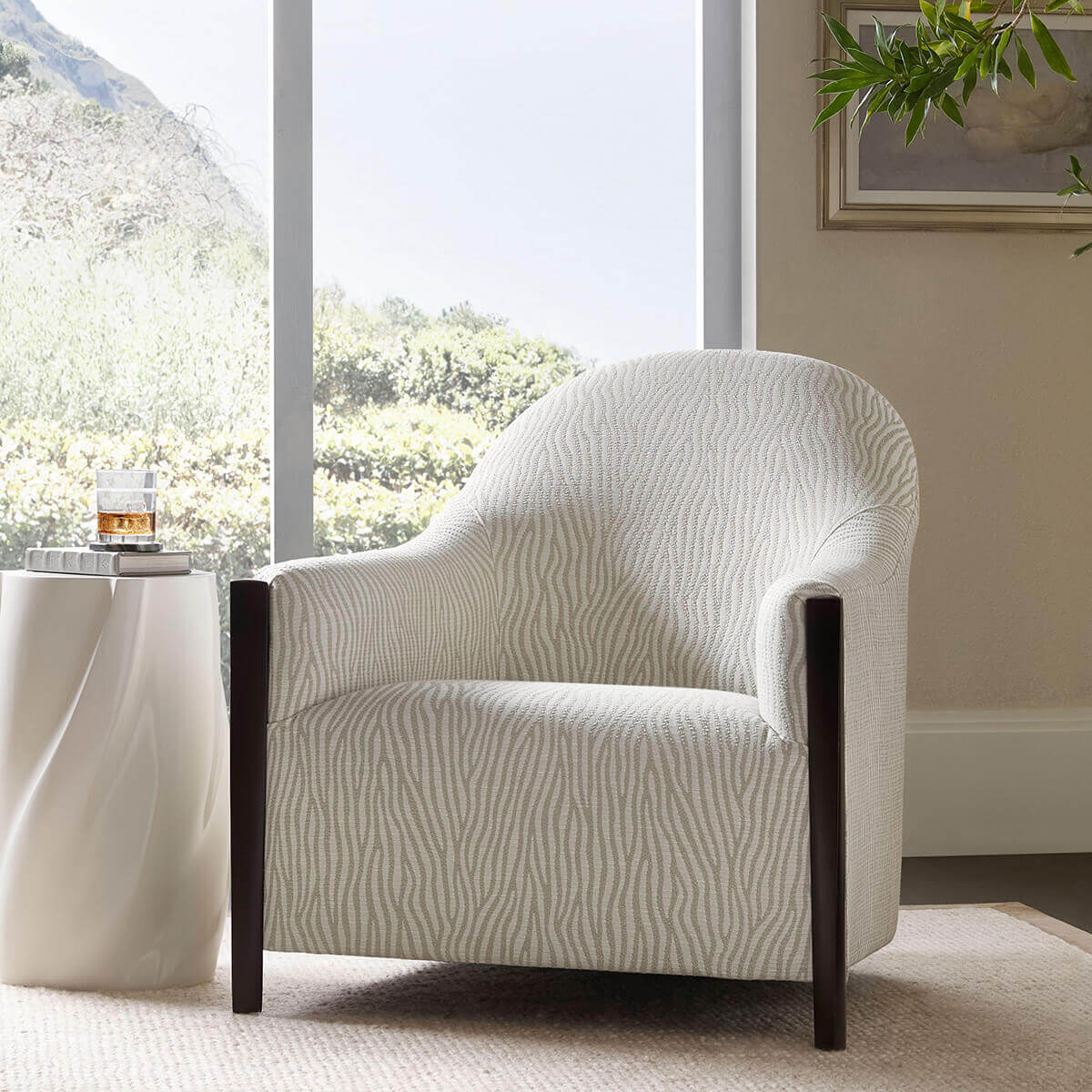 Helix Drinks Table beside chair in living room setting.