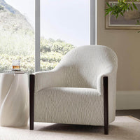 Helix Drinks Table beside chair in living room setting.