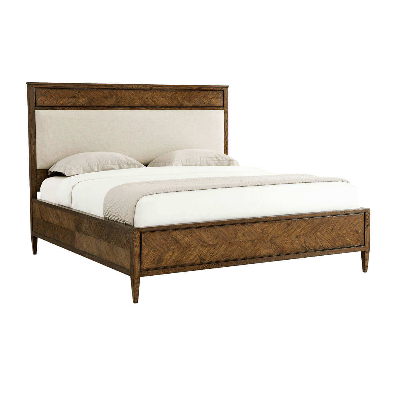 Angled view of herringbone parquetry California king bed.