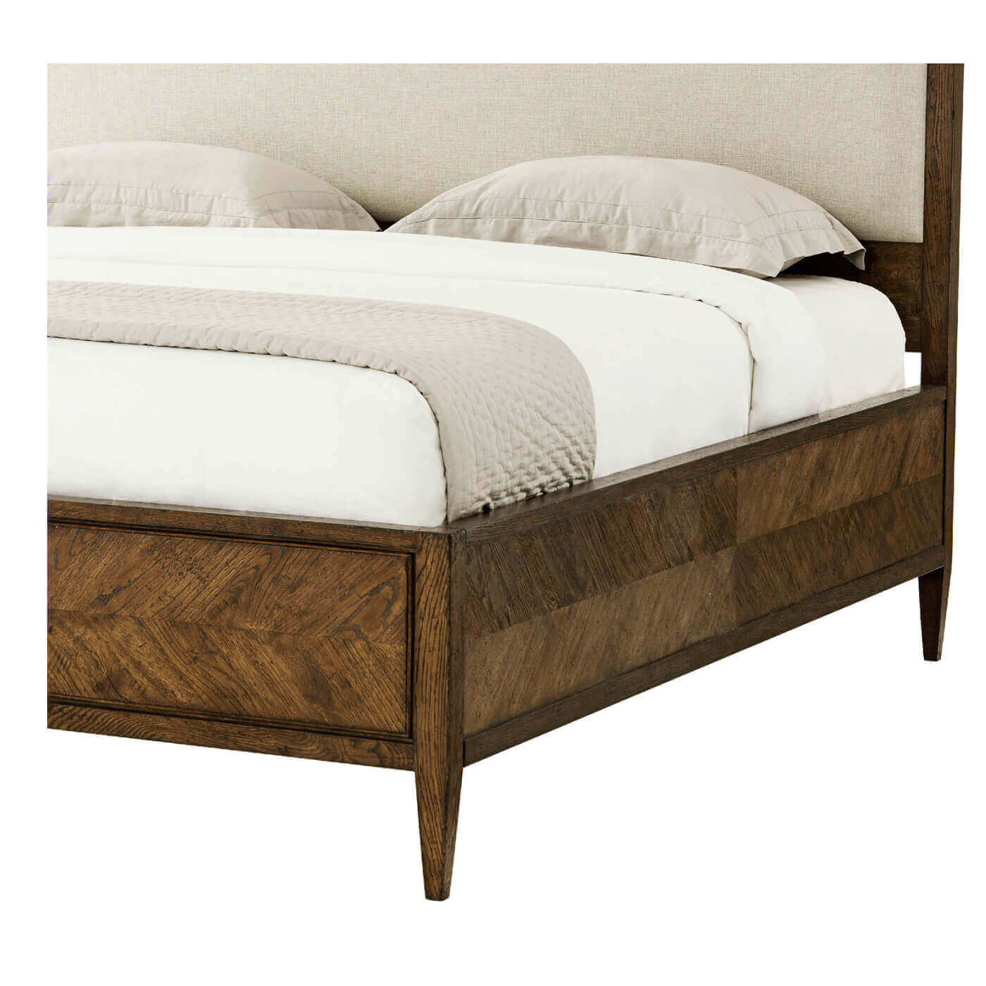 Side view, detail of footboard on dark oak bed.