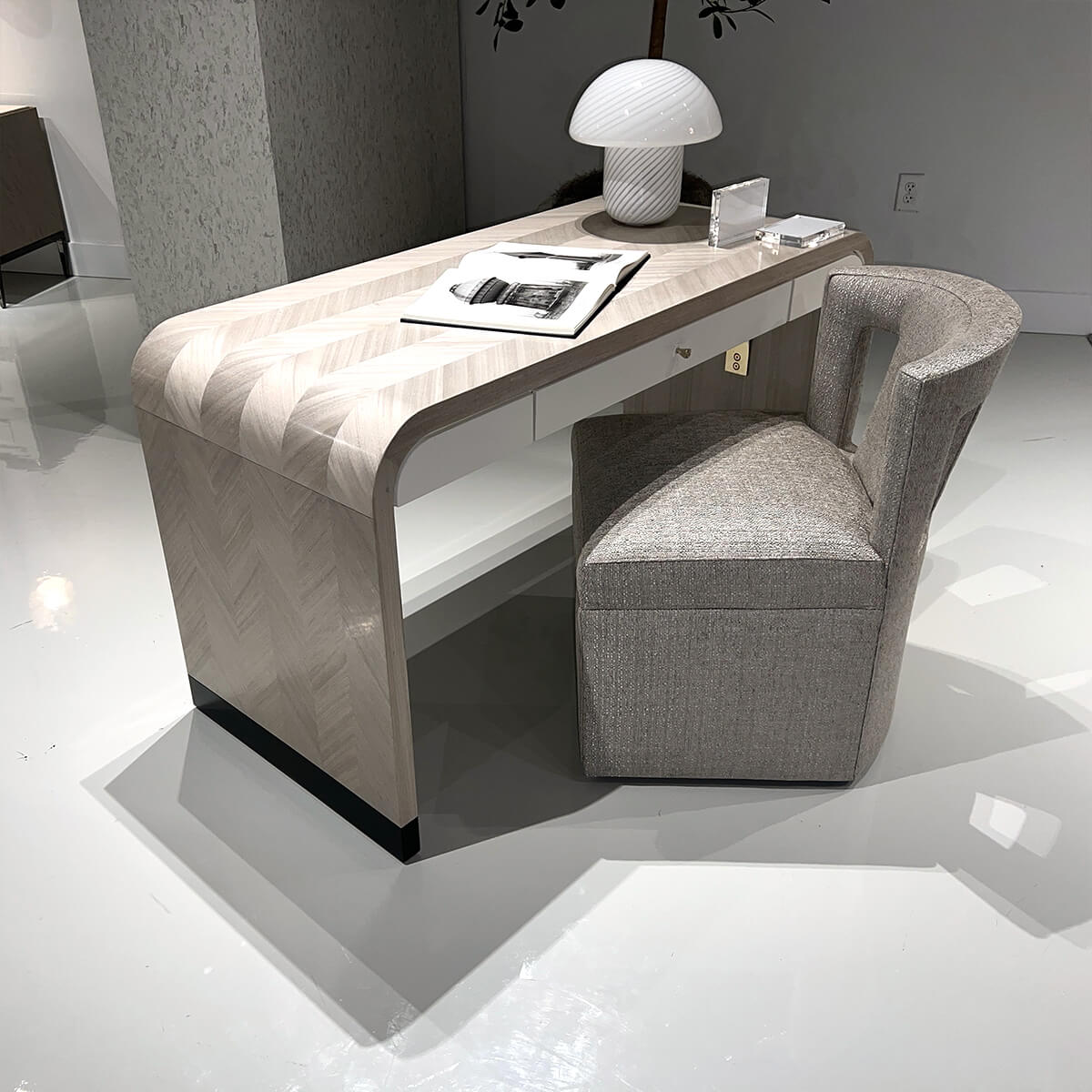 Herringbone desk paired with modern upholstered chair.