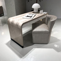 Herringbone desk paired with modern upholstered chair.