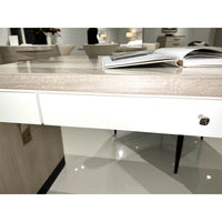 Herringbone desk focusing on white drawer and books.