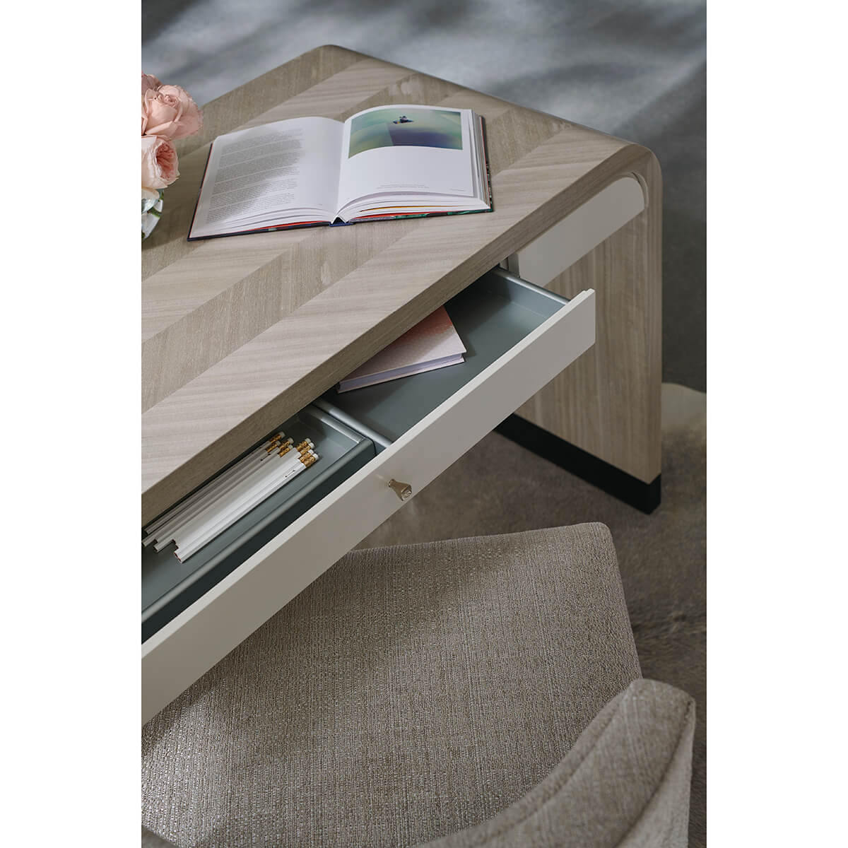 Close-up of desk drawer with organizer and stationery.