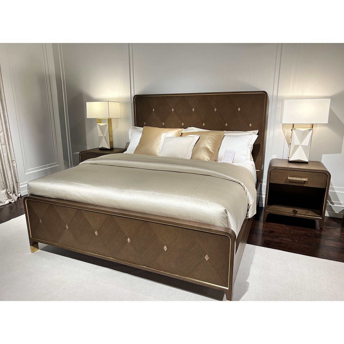 Bedroom setup with bedside table and lamps beside bed.